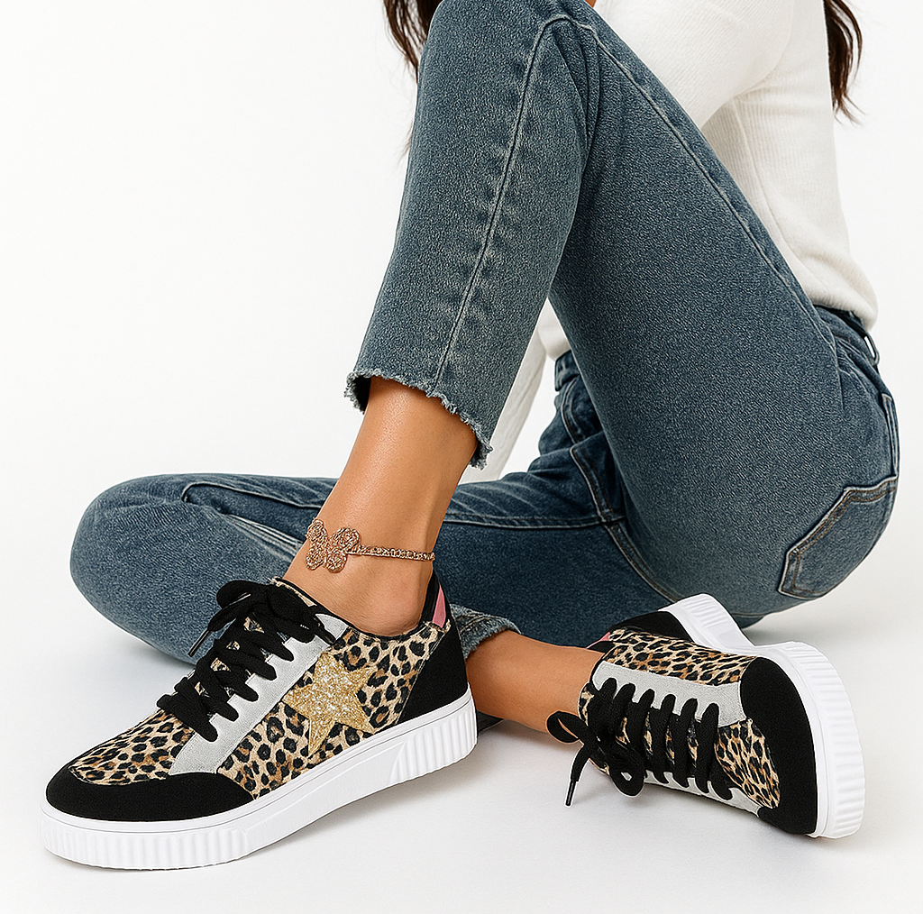 Person wearing leopard print sneakers with a white background